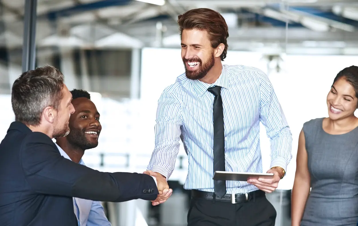 A smiling businessman shaking hands